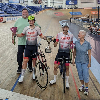 Red Peloton U23 Bike Racing Team member Chris Guzik (left) competing on the track at Hellyer Velodrome in San Jose.